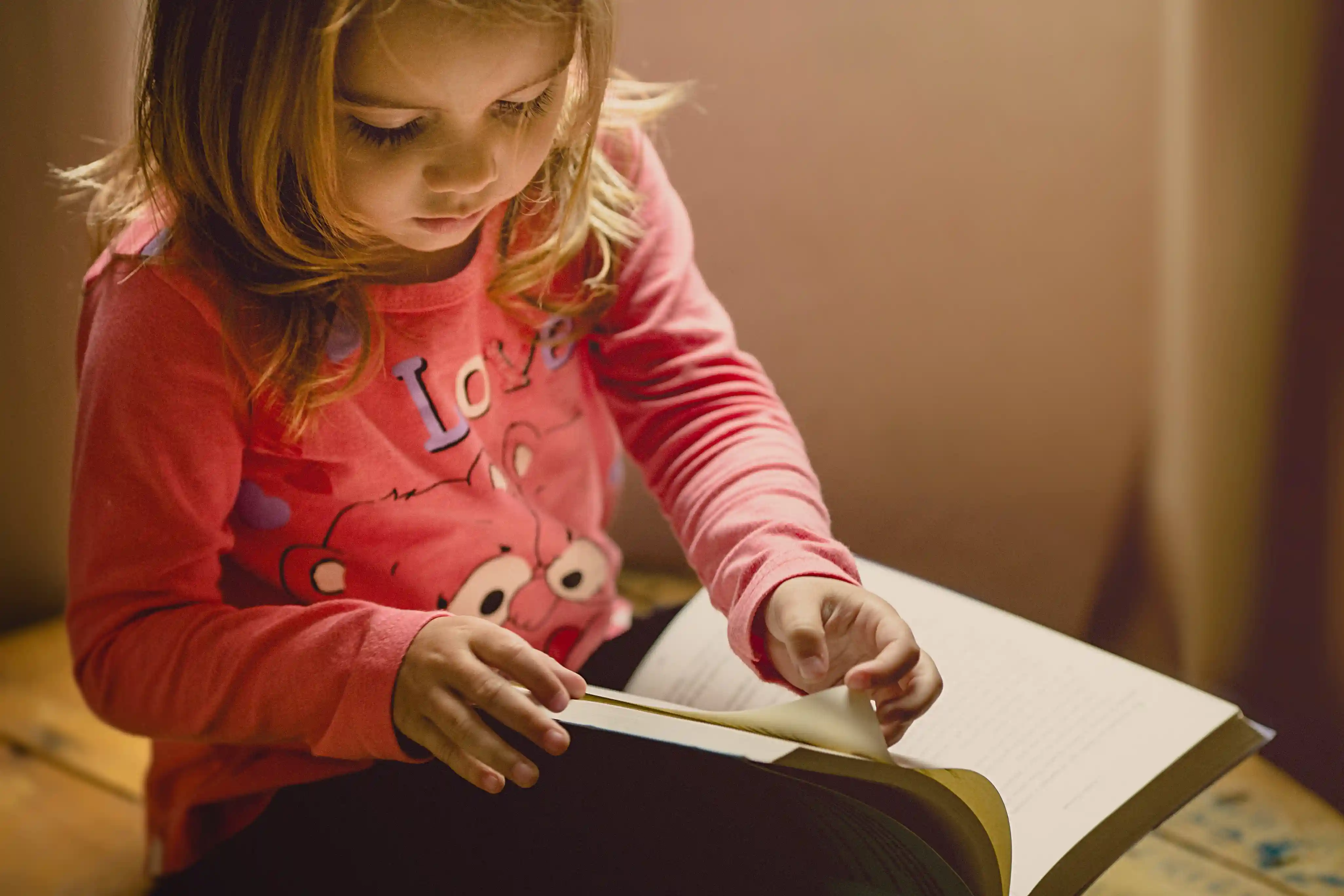 A young girl reading a book